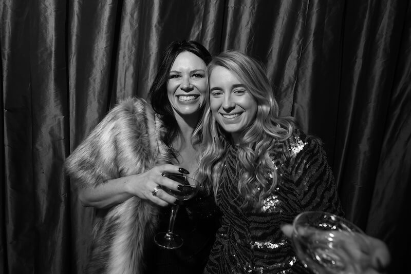 two women posing in black and white photo