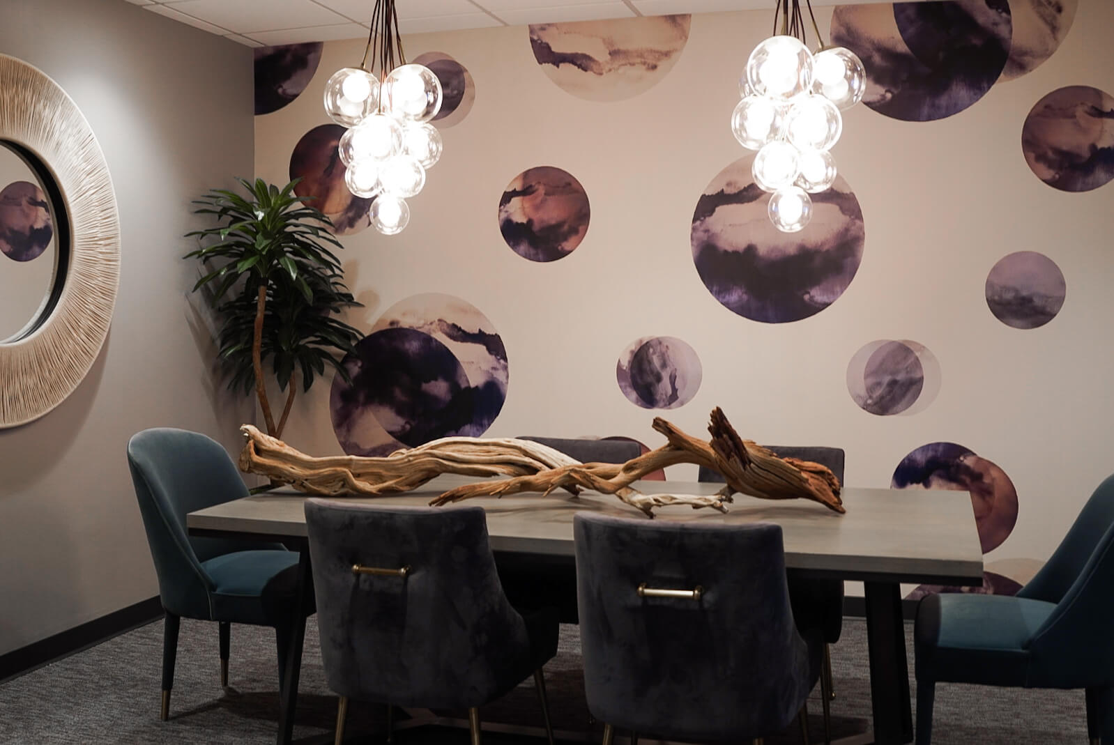 Conference room with patterned wallpaper and bubble chandeliers.