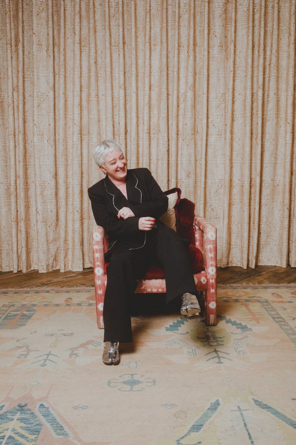 Hunter Claire Rogers laughs in a chair at Soho House Nashville