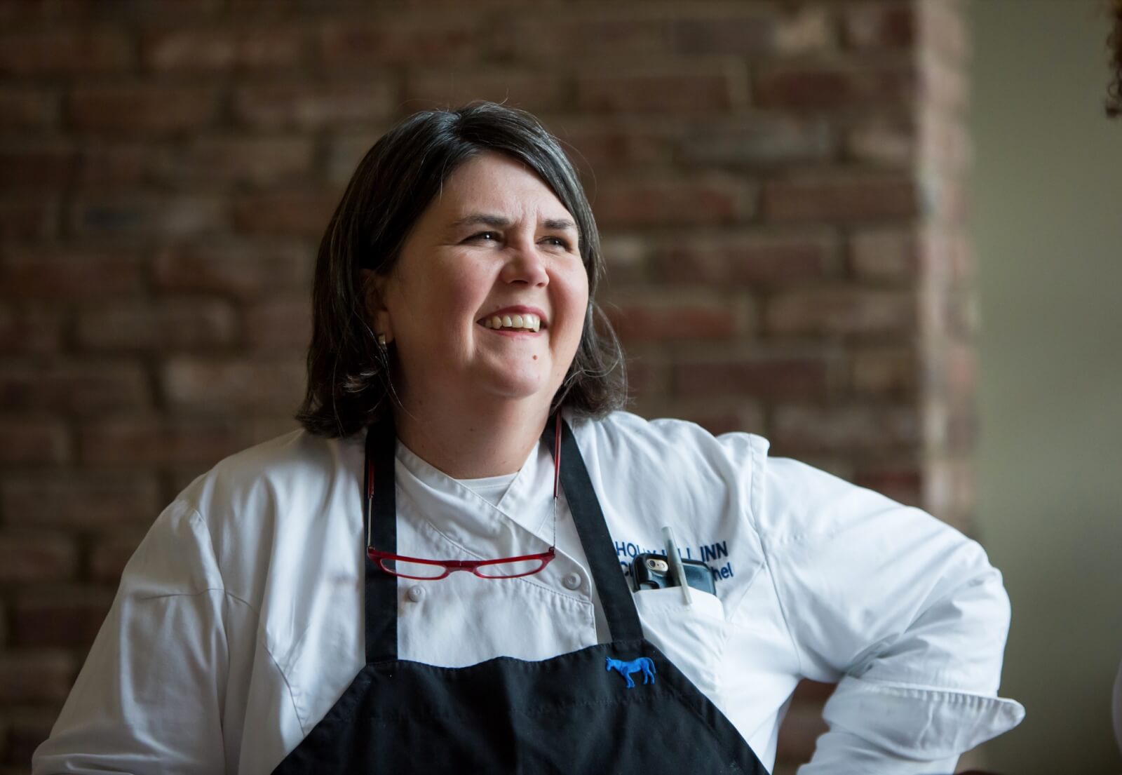 female chef looking off to the side and smiling