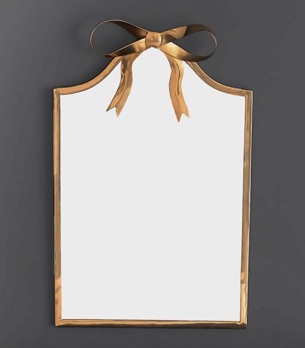 gold mirror with bow detail at top