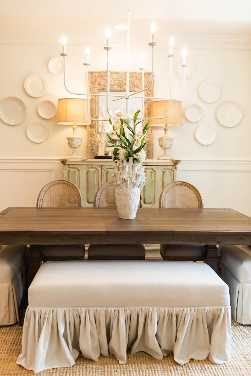 Formal dining room with chandelier and plates on wall for decor