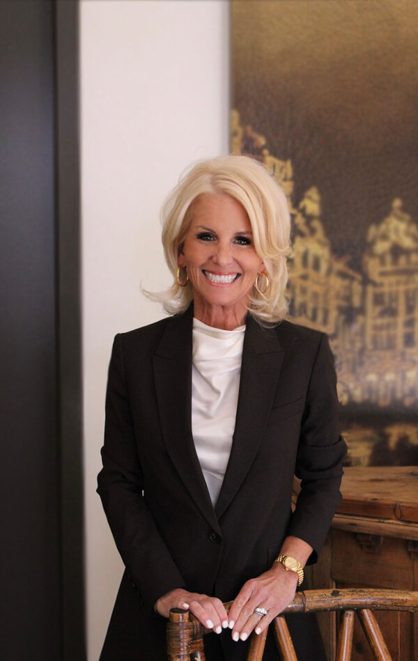 Woman with short, blond hair in a black blazer