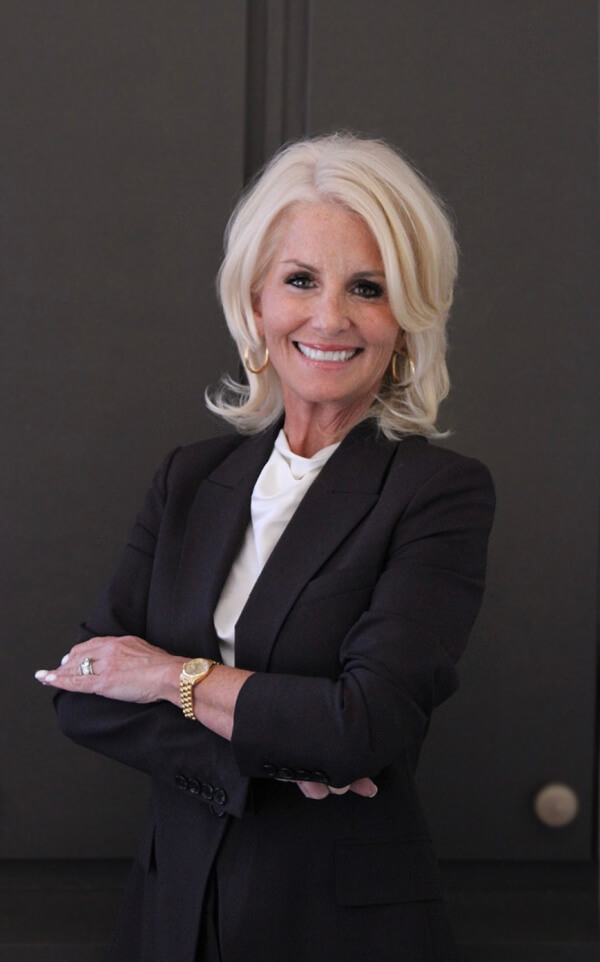 Woman in black blazer, smiling