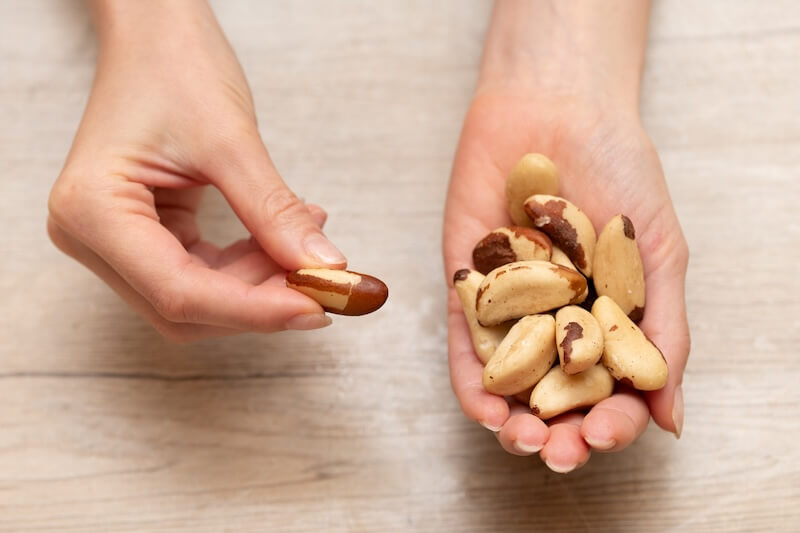 woman's hands holding brazil nuts