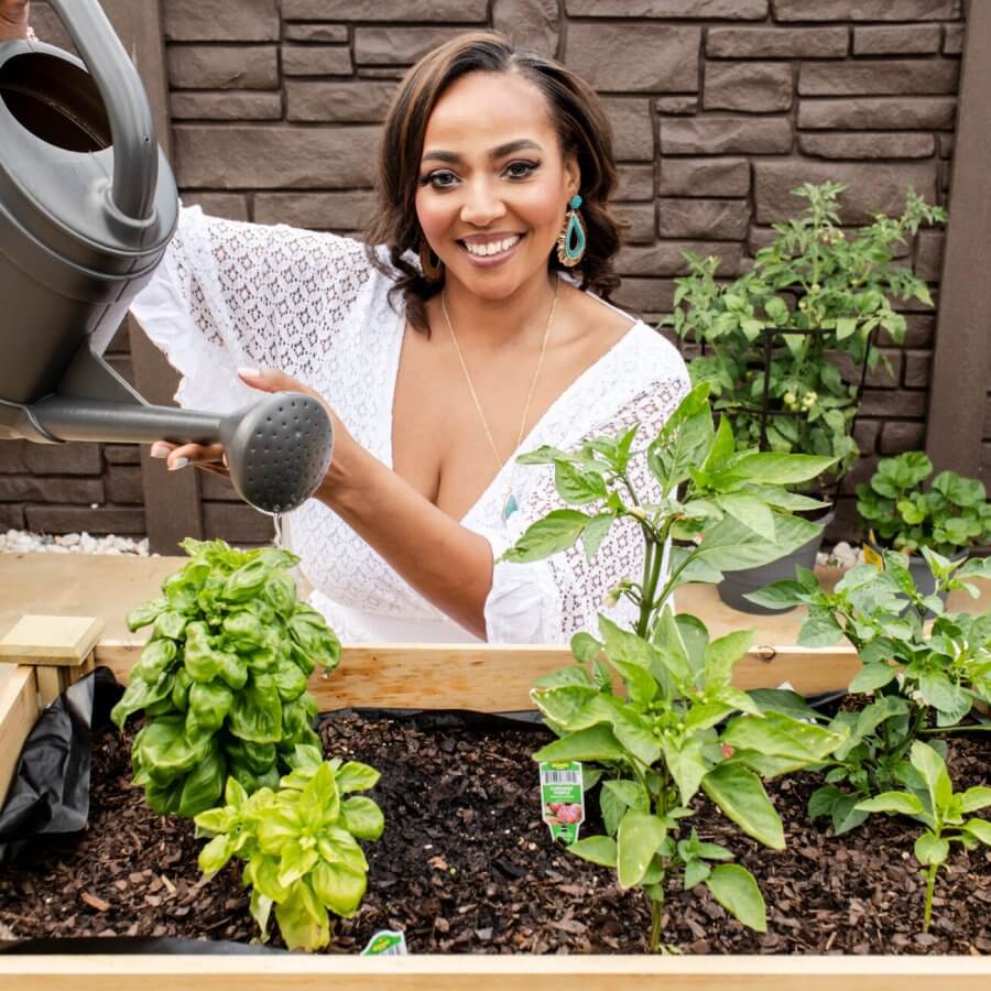 Chef Joya in a garden watering plants