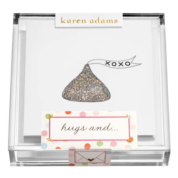 A box of stationery with a glittery chocolate design and "xoxo" text on the cards, featured as a Southern FINDS February favorite. Labels read "karen adams" and "hugs and...". The box is adorned with a colorful polka dot label at the bottom.