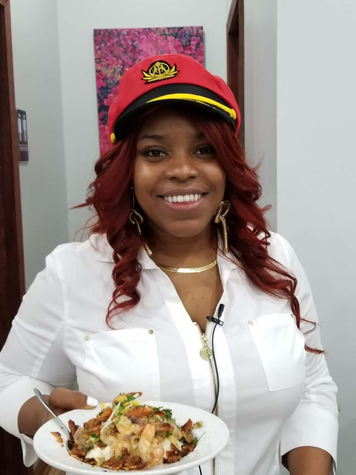 woman smiling and holding plate of food