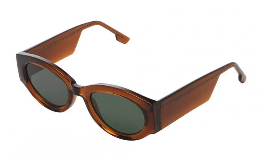 Discover your March FINDS with these brown, thick-framed cat-eye sunglasses featuring dark lenses and an angled view.