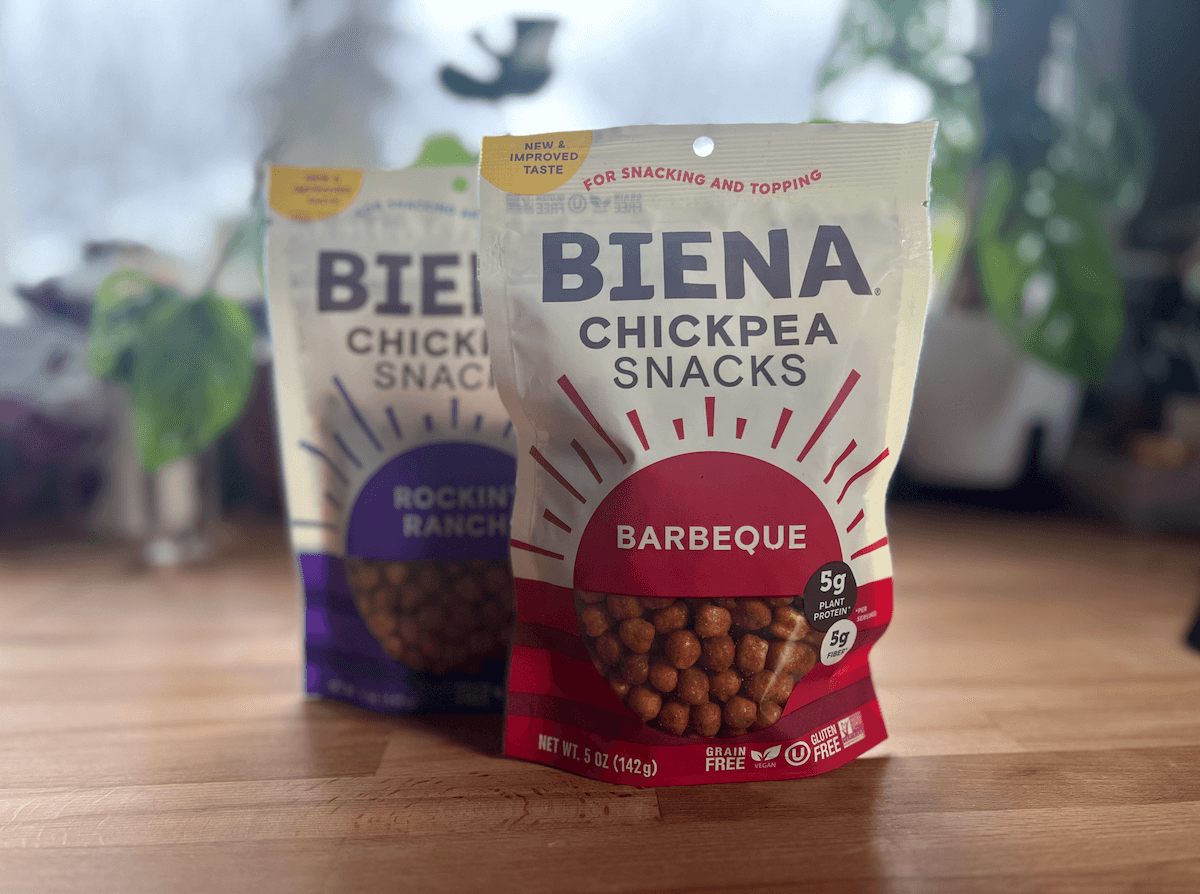 Two bags of biena chickpea snacks on a table.