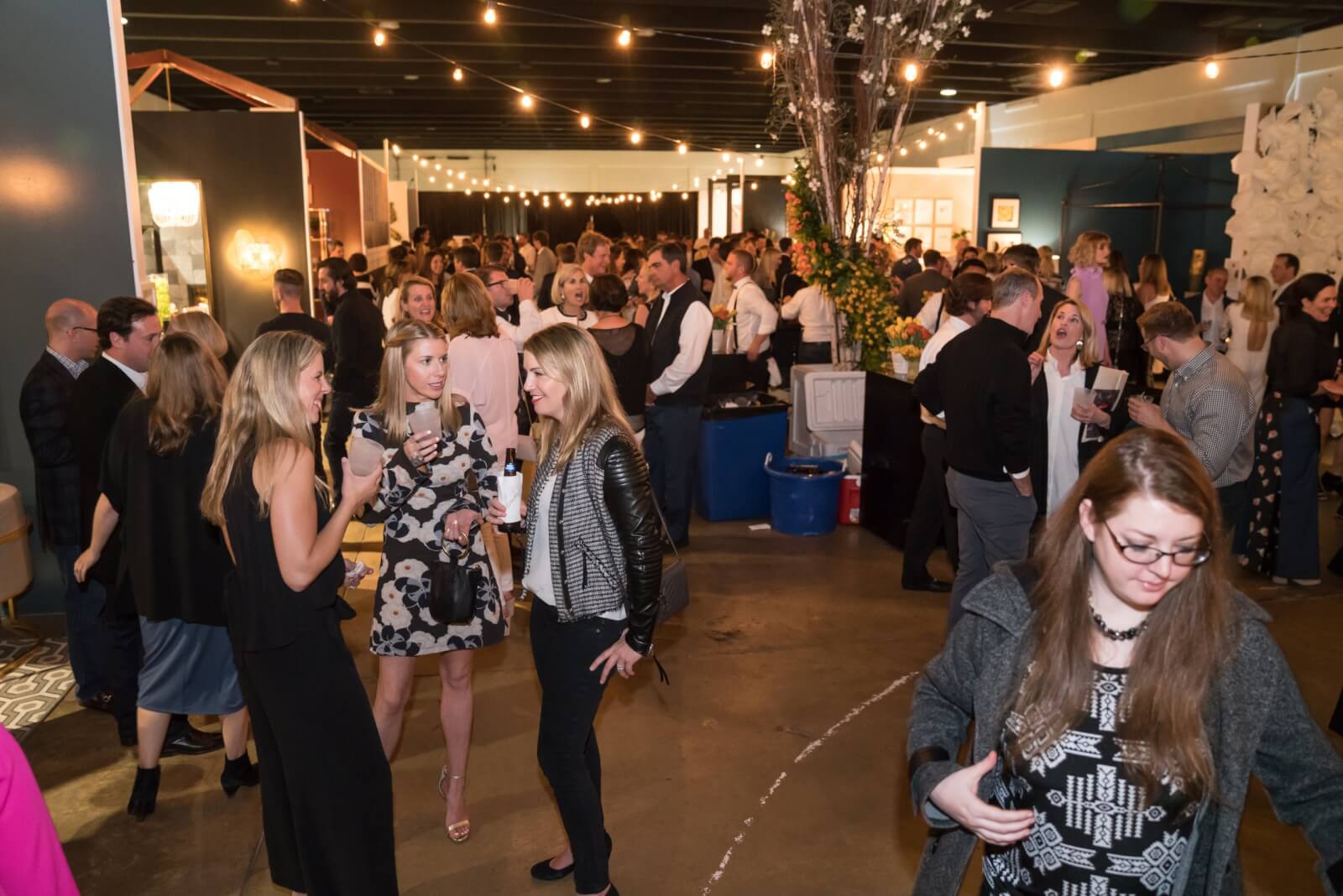 A group of people socializing at an indoor event.