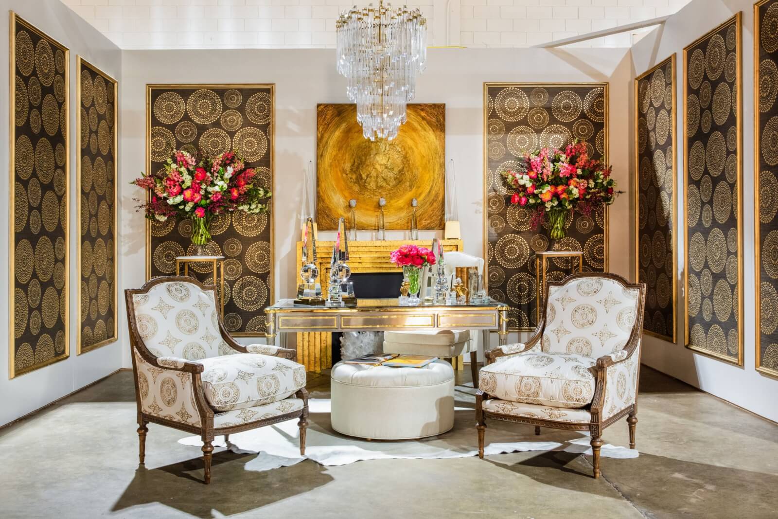 Elegant dining room setup with ornate chairs, a round table, vibrant floral arrangements, and decorative panels.