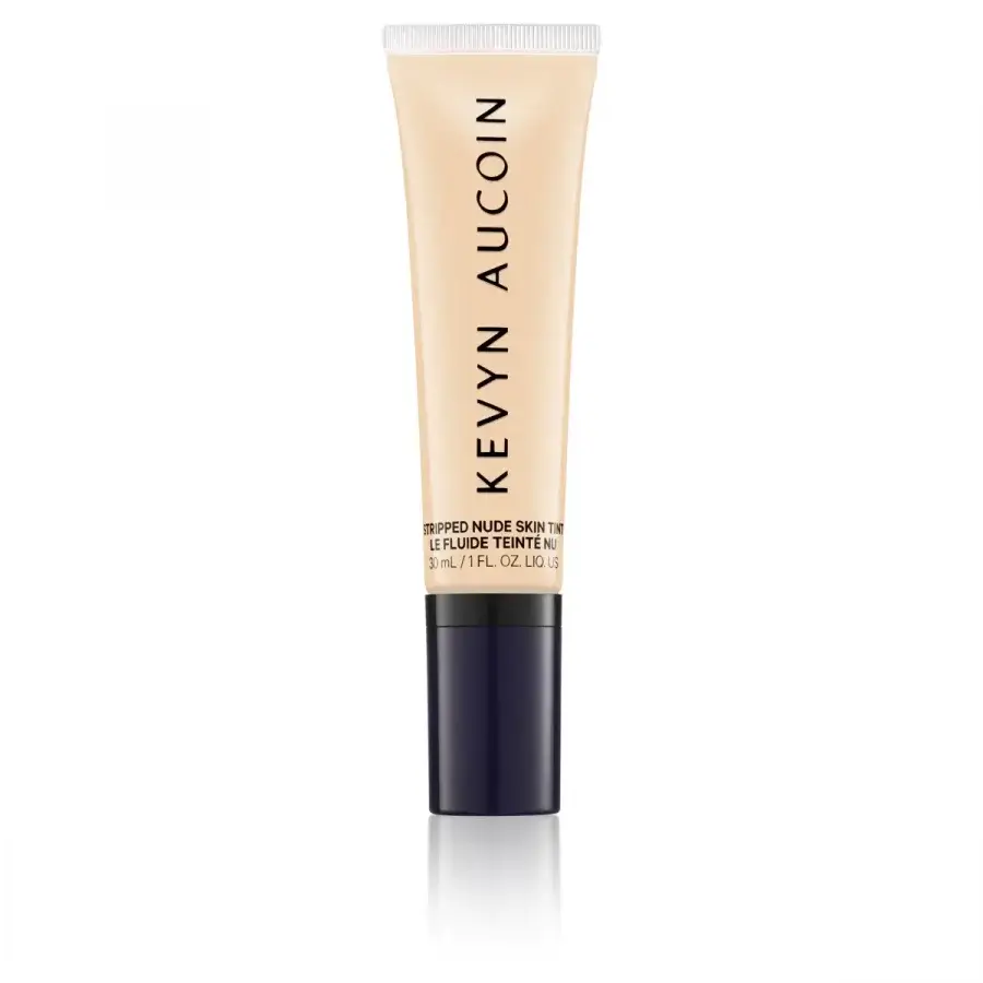 A tube of kevyn aucoin foundation on a white background.