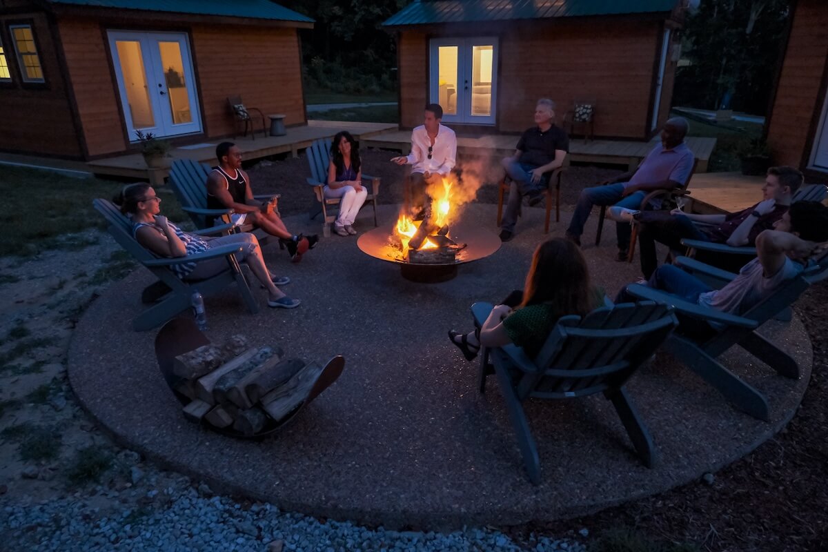 Group of people enjoying an evening around a fire pit.