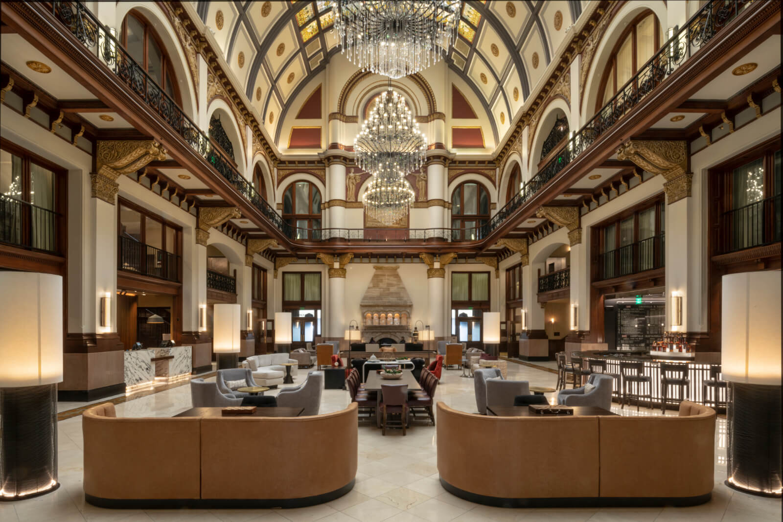 Elegant hotel lobby with grand chandeliers and plush seating.
