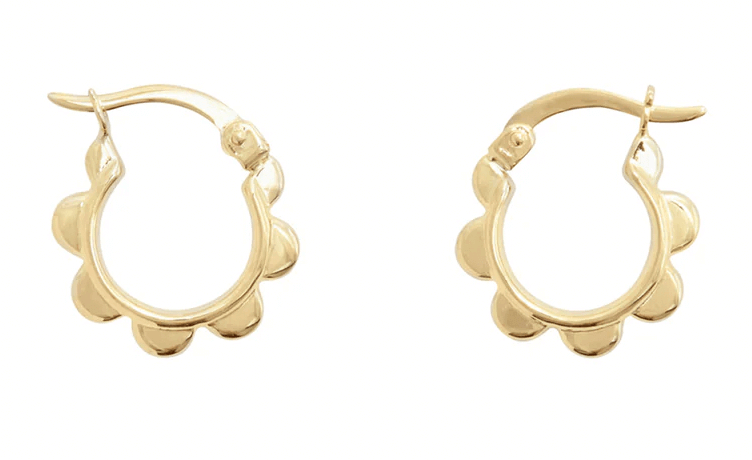 Two golden hoop earrings with a petal-like design, displayed against a white background.