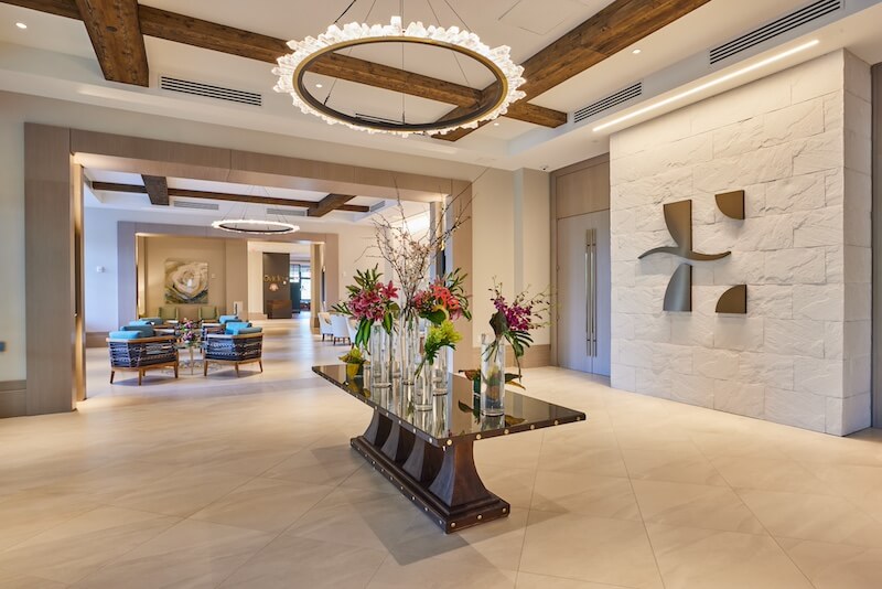 9 Boutique Hotels on the Emerald Coast - 5 Elegant 30a hotel lobby with modern decor and a floral centerpiece.
