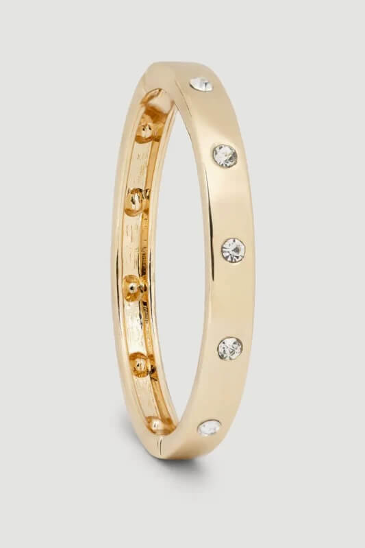 15 Memphis FINDS for May: Mother's Day & Spring Celebrations - 10 A gold band ring with evenly spaced small clear gemstones set around its surface, captured for Memphis FINDS May against a plain light background.