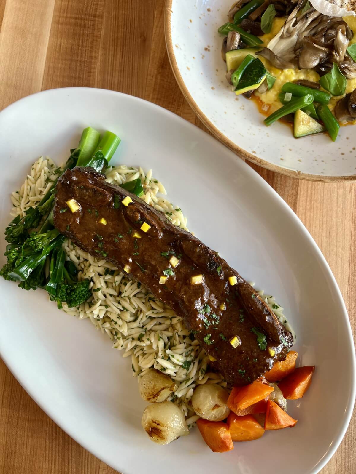 5 Local Experiences Every Memphian Should Try - 3 Plates of meat and vegetables on a wood table
