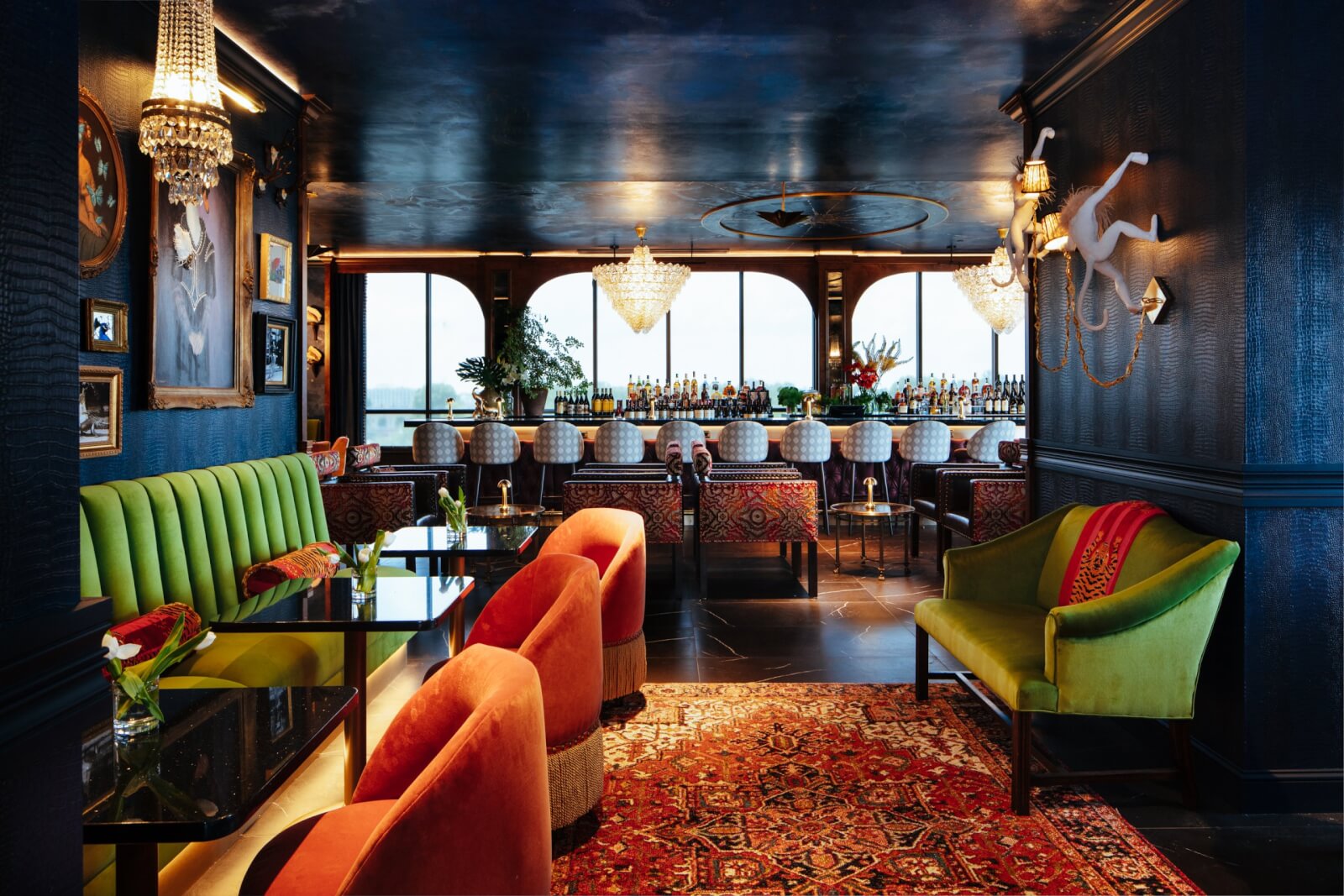 5 Local Experiences Every Memphian Should Try - 4 Interior of bar with green couches, orange chairs, and blue walls