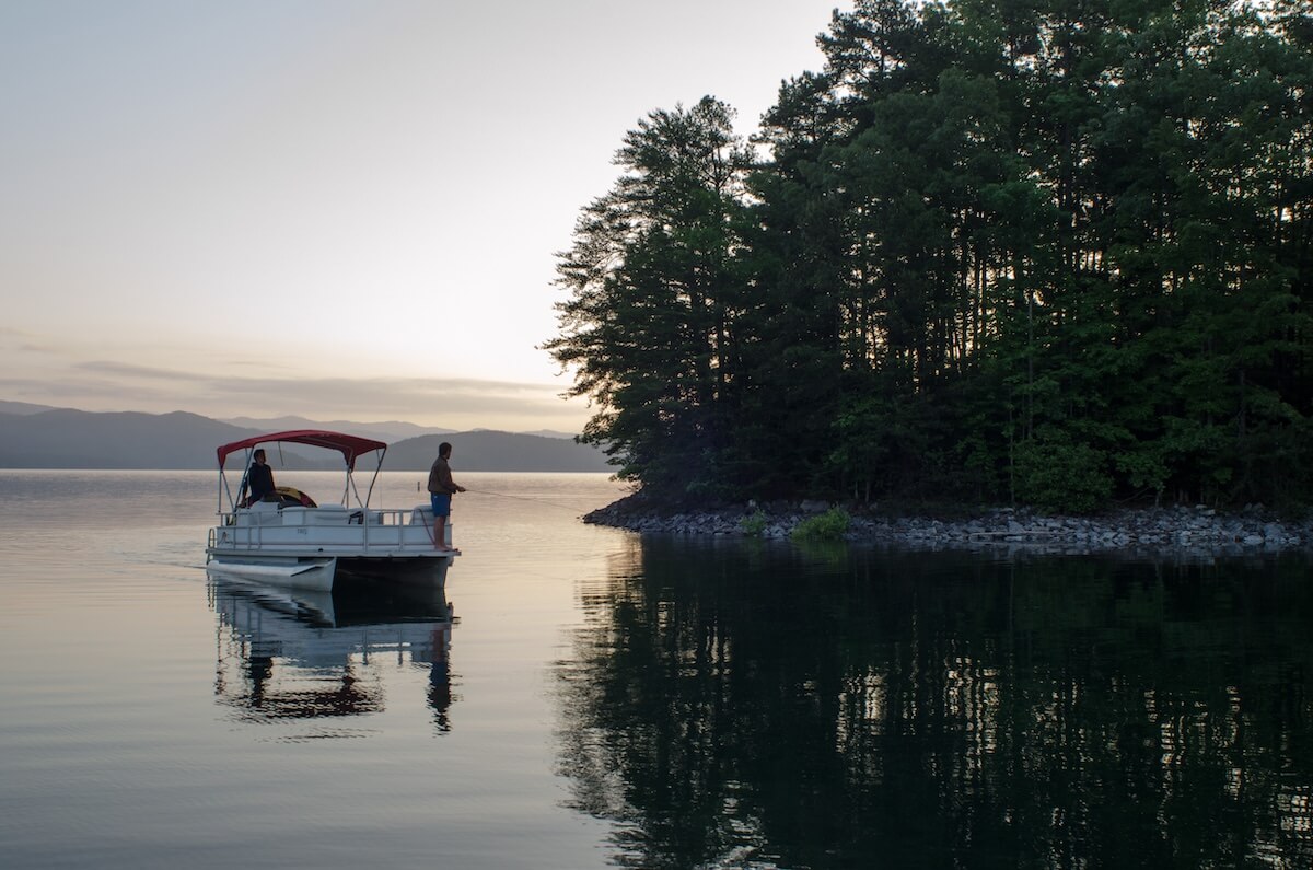 Two men on a pontoon boat fishing