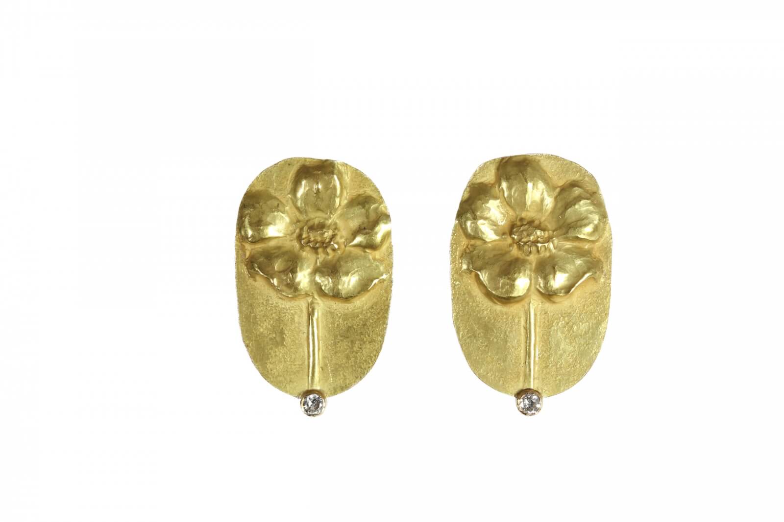 Gold earrings with a floral design, featuring a small, single diamond at the base of each earring, make for exquisite and expensive gift ideas.