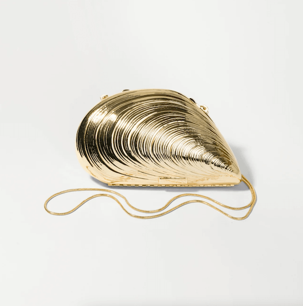 Gold seashell-shaped clutch bag with a metallic finish and a thin matching shoulder strap—a perfect pick for luxe loves, displayed on a plain white background.