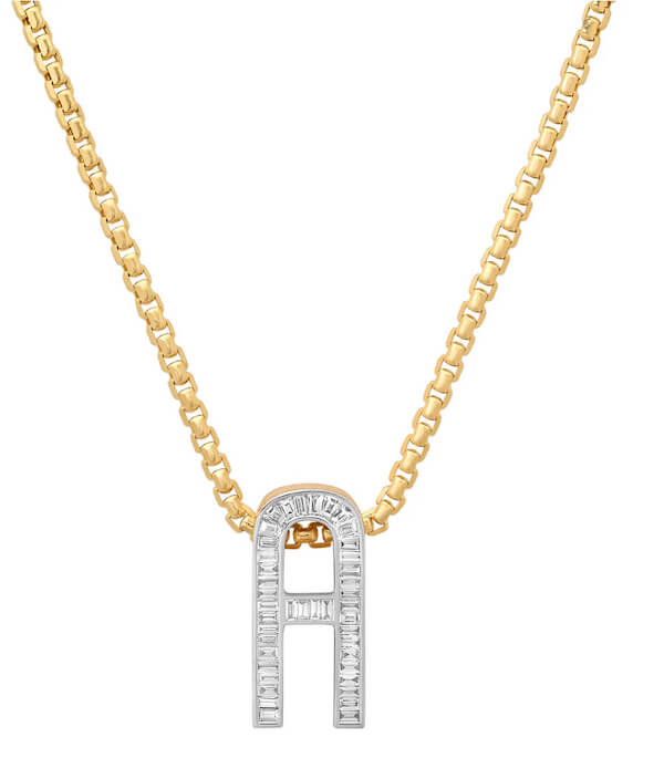 Gold chain necklace with a pendant shaped like the letter "A," embellished with small, rectangular clear stones—perfect for those luxe loves who appreciate personalized elegance.