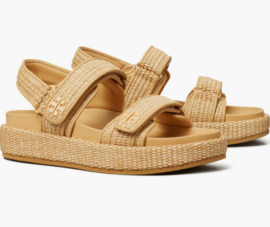 A pair of beige woven sandals with adjustable Velcro straps and a thick, textured sole, reminiscent of rattan decor.