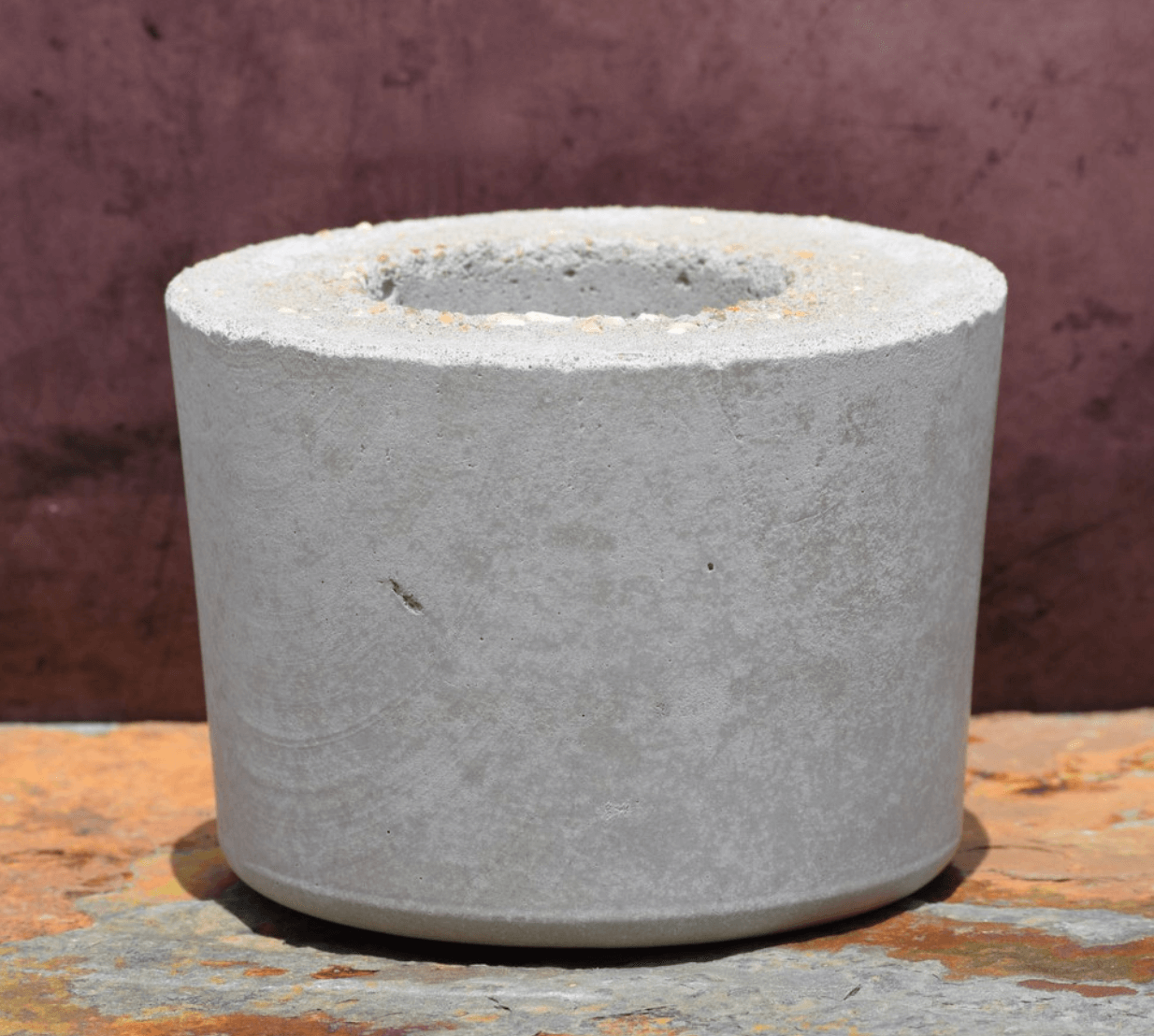 17 Birmingham FINDS Perfect for Summer - 13 A cylindrical concrete planter with a hollow center, part of the FINDS collection, displayed against a textured background.