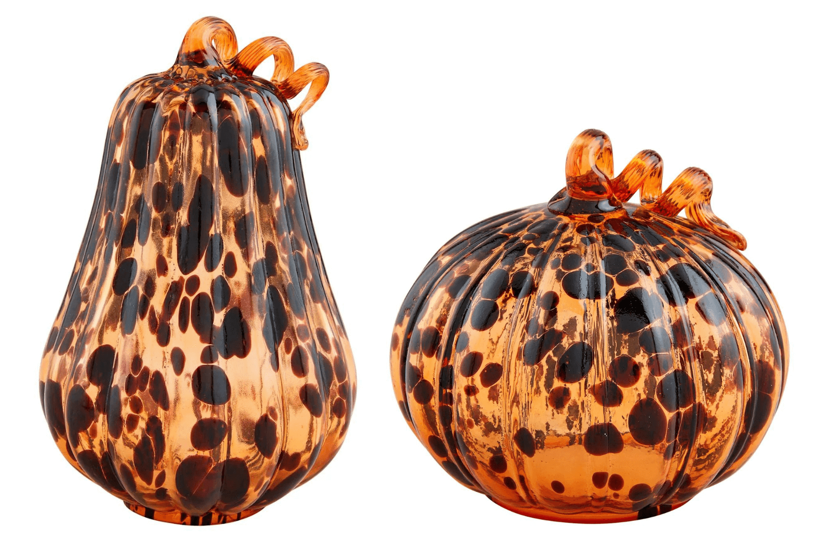Discover these exquisite glass sculptures in Nashville, beautifully crafted to resemble a pear and a pumpkin. Their transparent orange and black spotted design captures the essence of October, making them perfect seasonal FINDS.