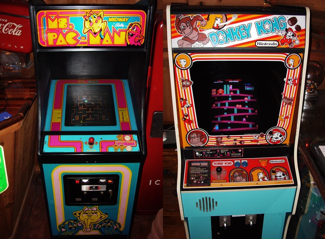 Two vintage arcade game machines. On the left is "Ms. Pac-Man" from Midway, and on the right is "Donkey Kong" from Nintendo. Both machines feature colorful designs and retro joysticks.