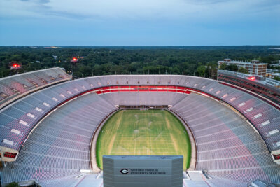Aerial view of an empty Sanford Stadium at the University of Georgia, showcasing the iconic field, seating, and scoreboard during daylight—a legendary home for University of Georgia football.