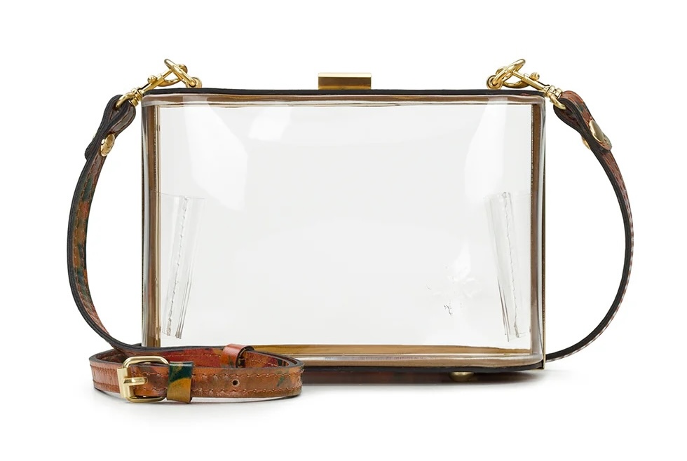 A rectangular, clear box purse with gold metal trim and a brown leather strap featuring a gold buckle—this chic accessory is perfect for those who love stylish clear bags.