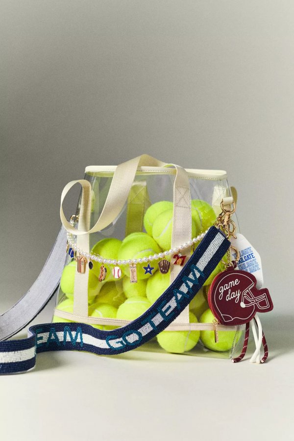 A clear bag filled with yellow tennis balls, featuring a wide navy and white "GO TEAM" strap and playful keychains—one reads "game day" with a football design. Perfect for showcasing your team spirit at events where clear bags are required.