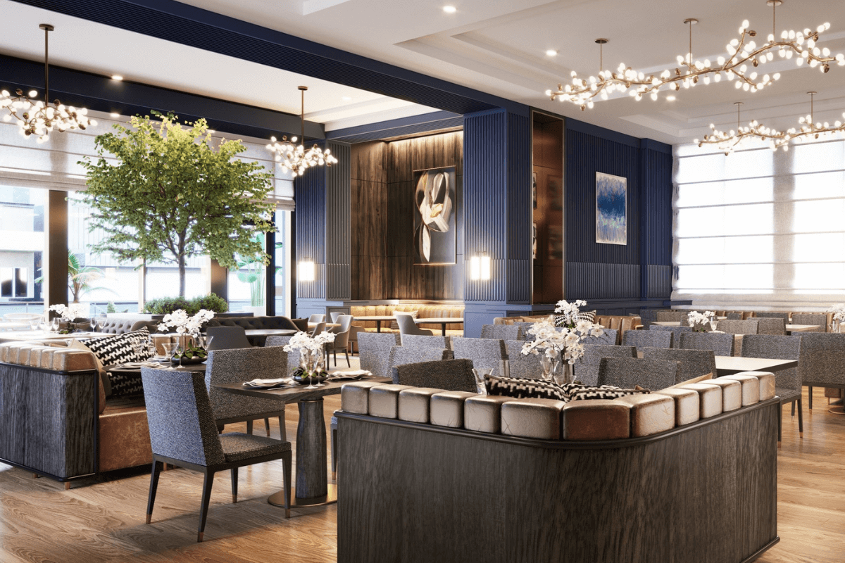 Located in Midtown, this elegant restaurant boasts a modern interior with gray seating, wooden tables, and chandeliers. A large indoor tree and art-adorned walls complement the ambiance while sunlight filters through expansive windows, offering a taste of Nashville's style.