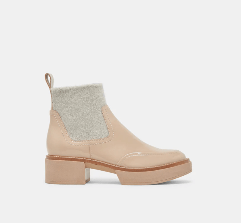 A beige ankle boot with a light grey felt upper section, block heel, and pull tab on the back