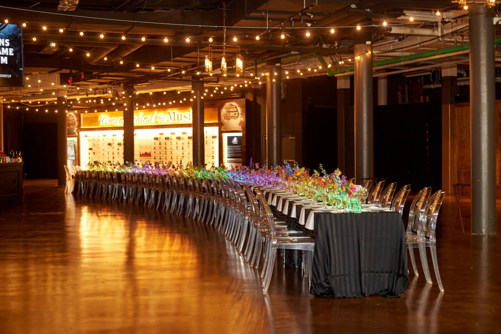 A long table set with flowers on it, perfect for a memorable Host & Toast gathering or an elegant evening arranged by our Luxury Concierge.
