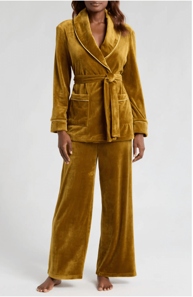 A festive vibe radiates from the mustard yellow velvet pajama set, perfect for any holiday morning. The ensemble, featuring a belted jacket and wide-leg pants, exudes comfort and style in equal measure.