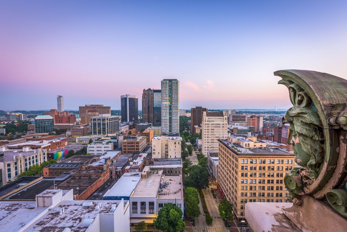 A panoramic view of downtown Birmingham, Alabama at sunset, with modern high-rises and historic buildings under a clear sky—the perfect backdrop for exciting Birmingham events in January.