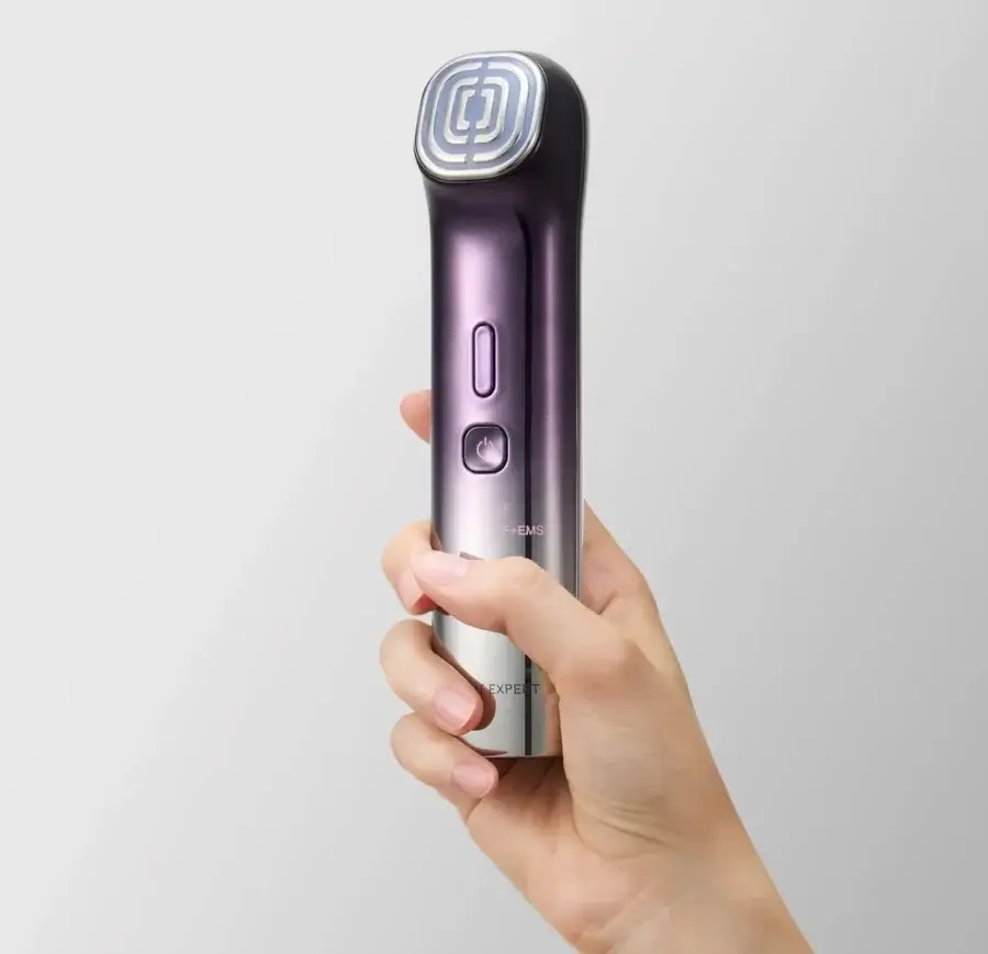 17 Birmingham FINDS for the New Year - 10 A hand holding a sleek, metallic beauty device with buttons and a patterned treatment head, featured as one of Birmingham FINDS January highlights, set against a plain light background.