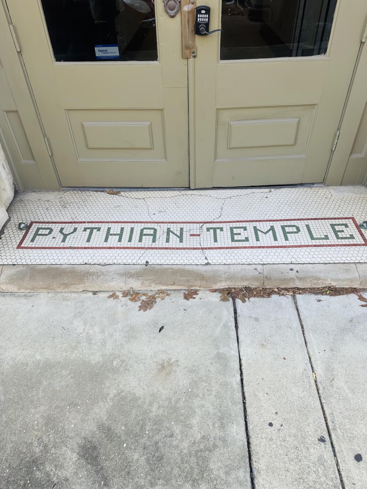 The entrance, with its grand double doors and a tiled threshold proudly displaying "PYTHIAN TEMPLE," invites you into a world steeped in history, right in the heart of Alabama.