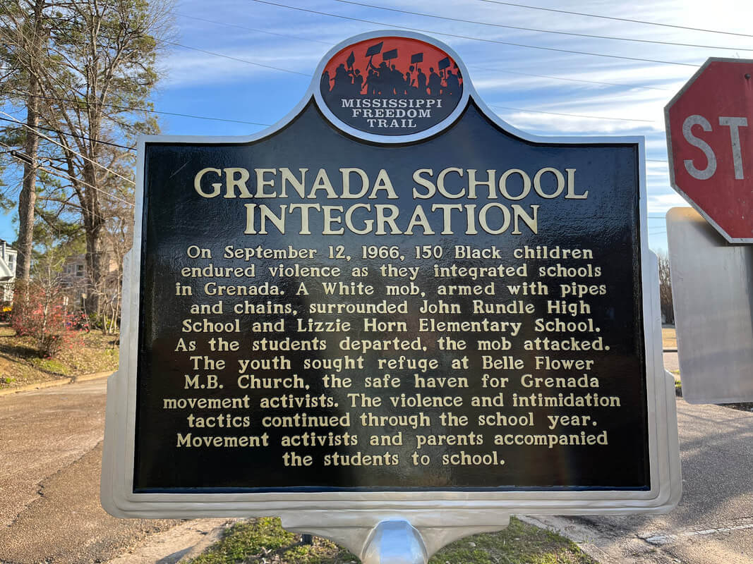 The historical marker titled "Grenada School Integration" is a poignant stop on Mississippi's Freedom Trail, guiding visitors through the harrowing violence faced by 150 Black children during school integration in Grenada in 1966.