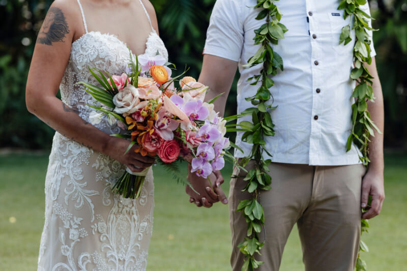 Lennie and William hold hands, celebrating their wedding day. 