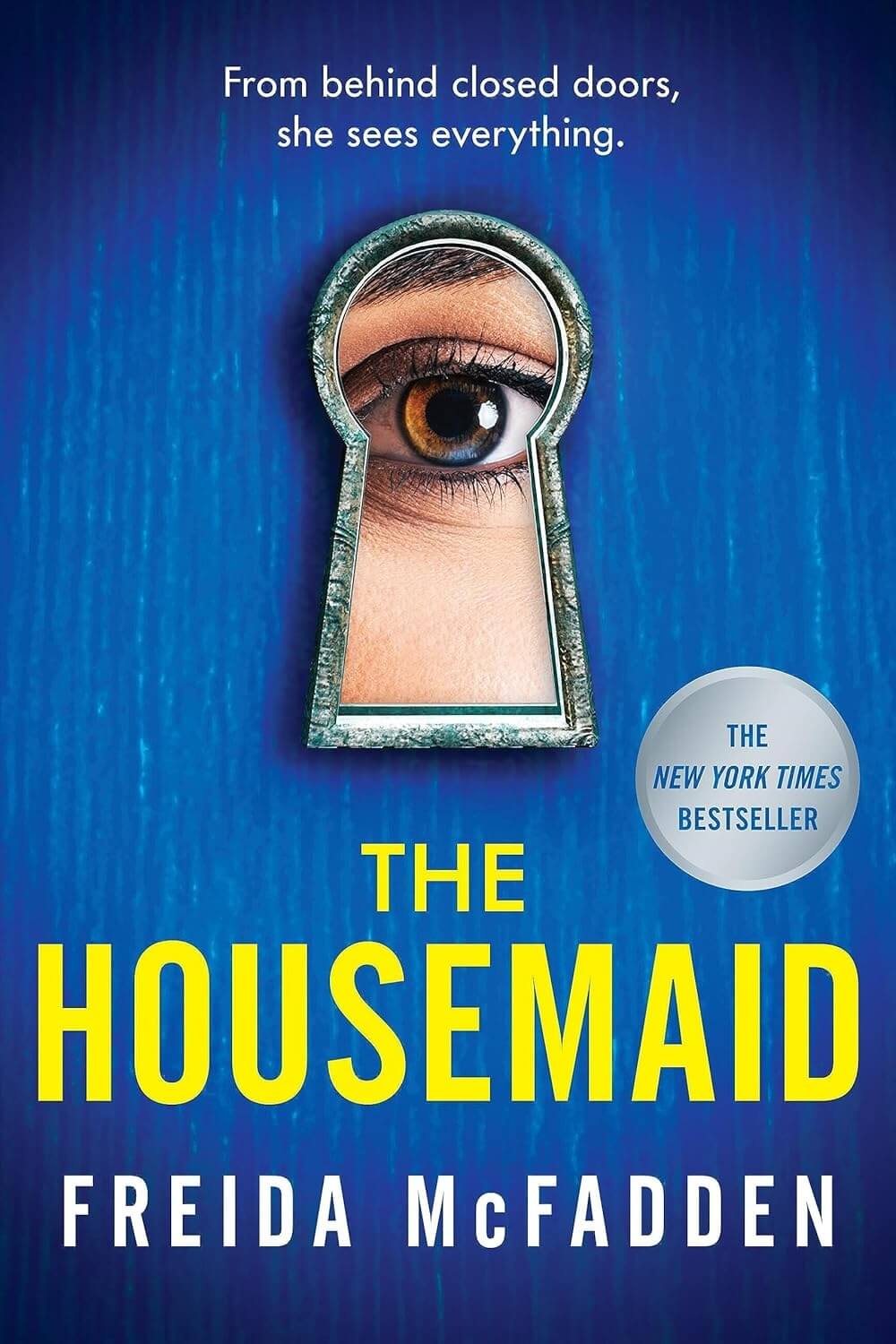 The cover of "The Housemaid" by Freida McFadden, part of Brianna's Books recommended reads for Summer 2025, showcases a haunting human eye peering through a keyhole. Adorned with a "New York Times Bestseller" badge, it promises intrigue and suspense.