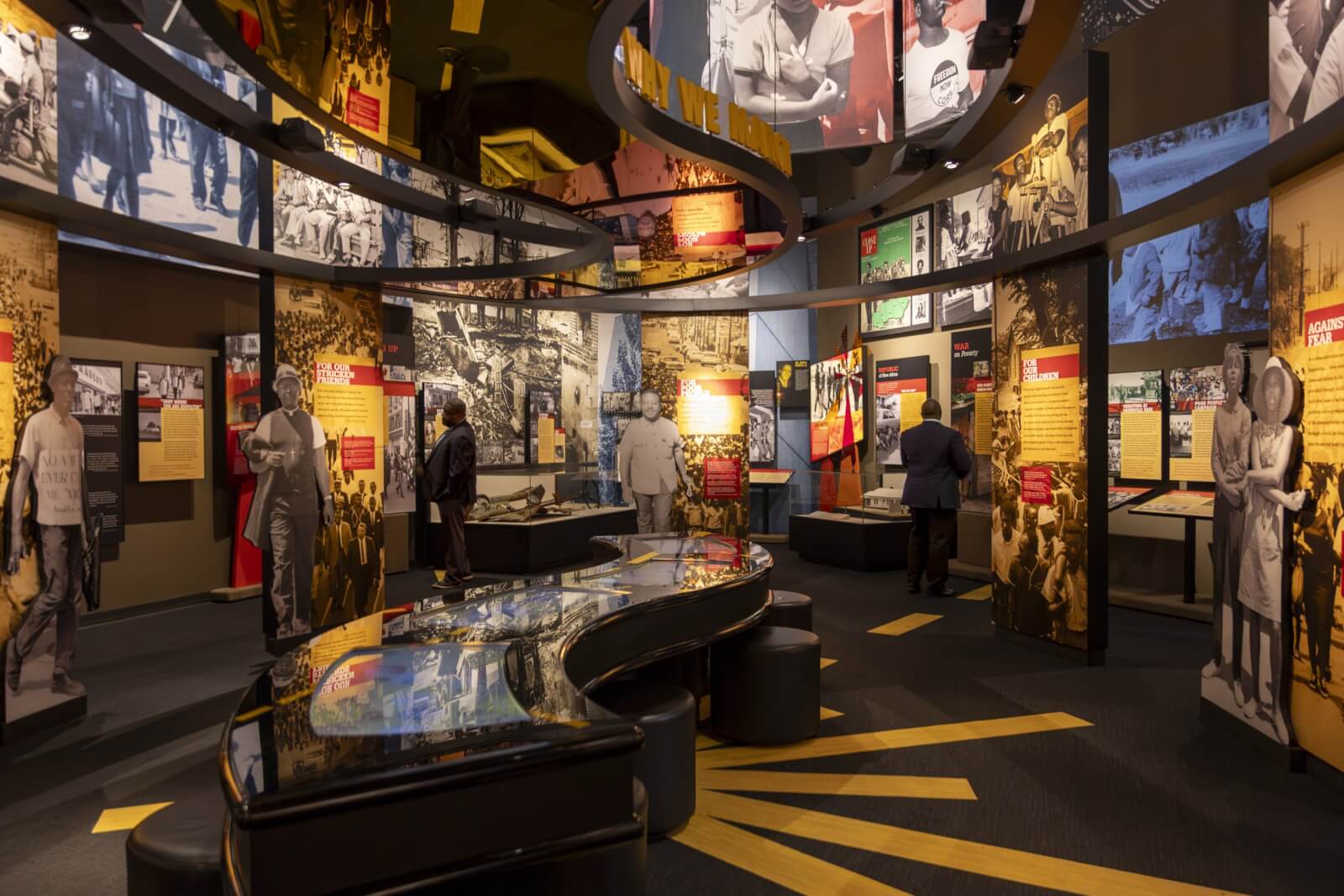 The museum exhibit features historical photographs and informational displays, inviting visitors to explore the Mississippi Freedom Trail through archival images and text panels on curved walls.