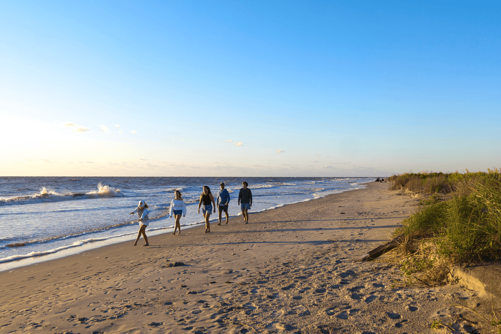 7 Best Family Vacations for Outdoor Fun - 1 Family walking along the beach in Golden Isles.