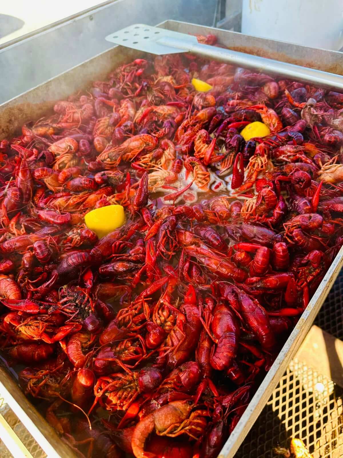 A large metal tray filled with boiled crawfish and a few lemon wedges awaits at one of Birmingham's exciting new restaurants. Steam rises invitingly as a spatula rests on the side.