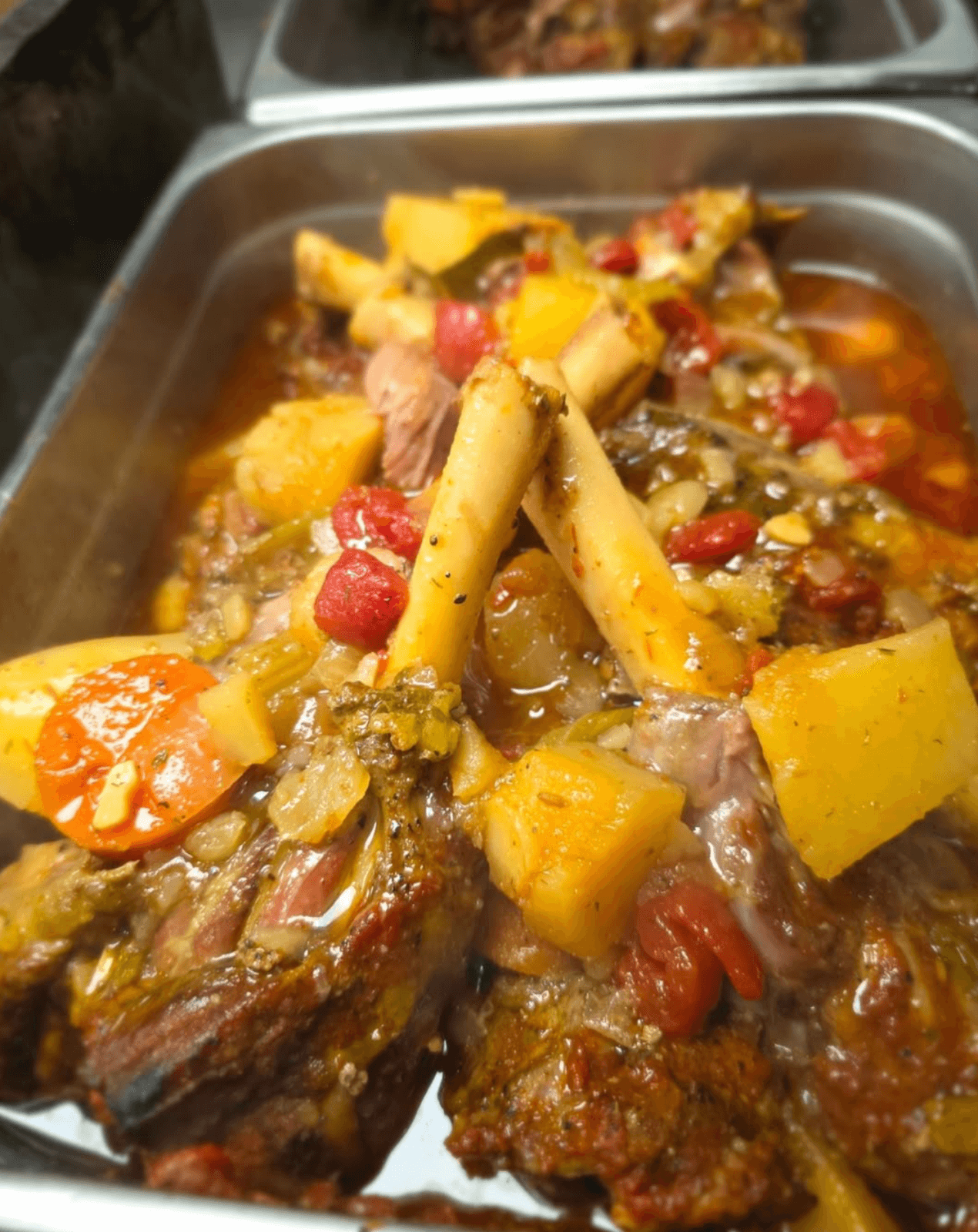 In Birmingham's new restaurant scene, discover a tray of cooked meat bones with chunks of potatoes, tomatoes, and herbs in broth—a delightful concept that melds traditional flavors with modern flair.