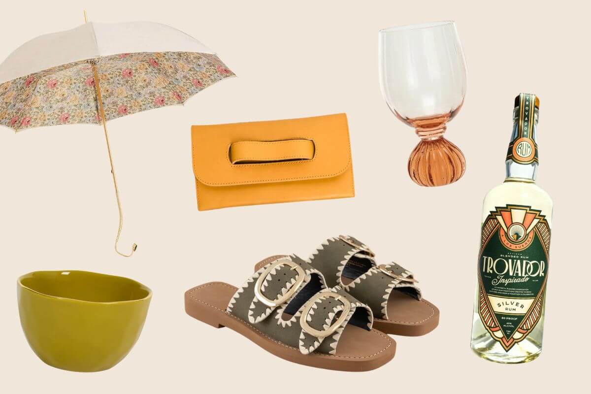 In this April-inspired collection, discover Nashville's finest FINDS: an umbrella, a yellow clutch, a wine glass, a bottle of liquor, olive sandals, and a green bowl artfully arranged on a beige background.